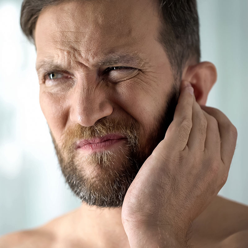 Man holding his ear