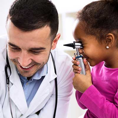 Child looking in a pediatric ent doctor's ear